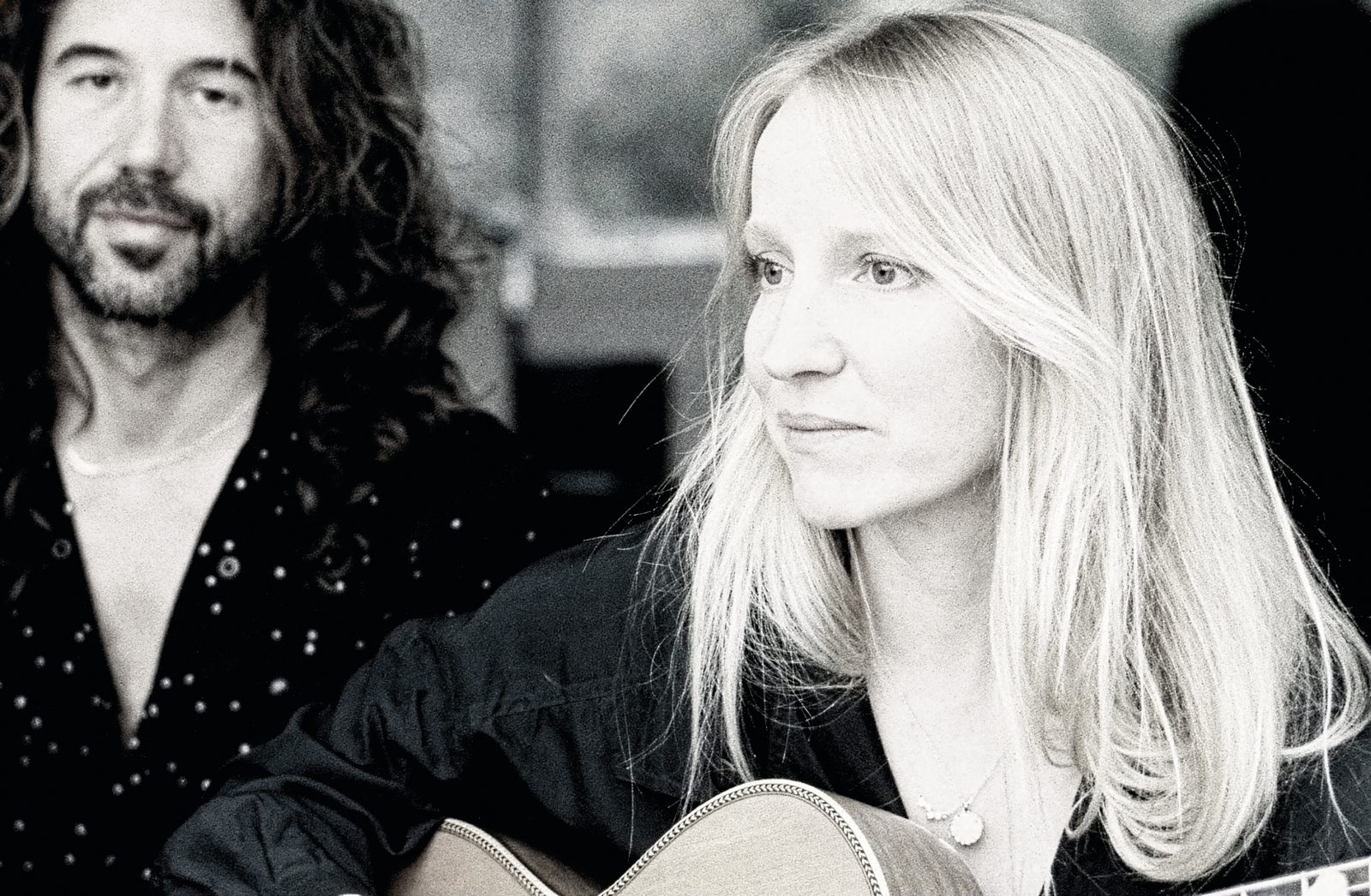 Zoë Randell and Steve Hassett of Luluc, black and white portrait with acoustic guitar